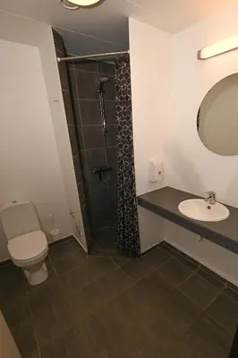 a bathroom with a toilet and a sink and a shower at Sport & Academy in Farsø