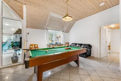 a living room with a pool table in it at Family-Friendly Holiday Home With Pool And Spa Close To The North Sea in Harboør