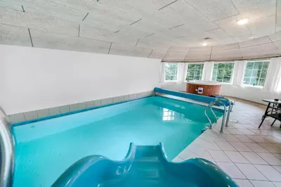 a large swimming pool in a room at Family-Friendly Holiday Home With Pool And Spa Close To The North Sea in Harboør