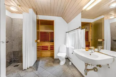 a bathroom with a sink and a toilet and a shower at Family-Friendly Holiday Home With Pool And Spa Close To The North Sea in Harboør