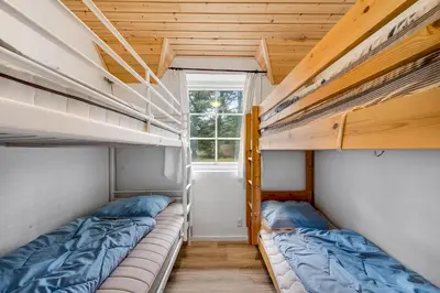 two bunk beds in a room with a window at Family-Friendly Holiday Home With Pool And Spa Close To The North Sea in Harboør