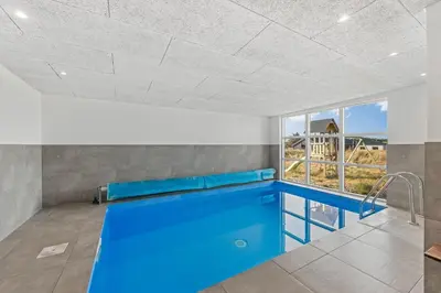 a swimming pool in a room with a ceiling at Pool House With Activity Room, Built In 2020, With A View Of The North Sea in Nørre Vorupør