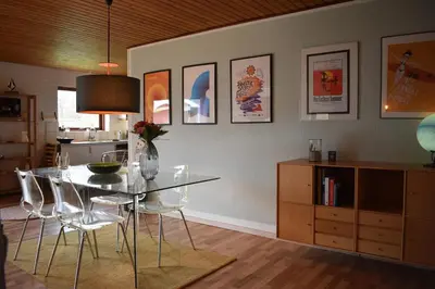 a dining room with a glass table and chairs at Viking Surf Camp in Klitmøller