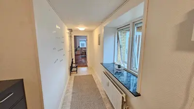 a hallway with a counter and a window at Nattely i Thy in Thisted