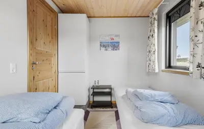 a bedroom with two beds and a window at 5 Bedroom Lovely Home In Saltum in Saltum