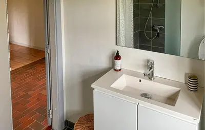 a bathroom with a white sink and a mirror at Stunning Home In Øster Assels With Wifi in Øster Assels