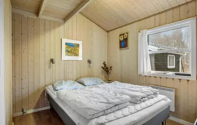 a bedroom with a bed in a room with a window at Lovely Home In Fjerritslev With Sauna in Fjerritslev