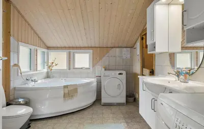 a bathroom with a tub and a toilet and a sink at Lovely Home In Fjerritslev With Sauna in Fjerritslev