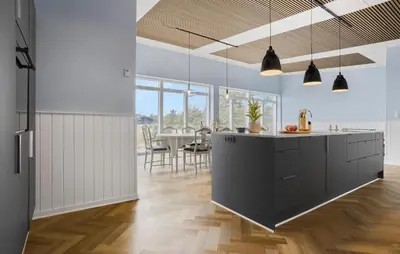 a kitchen with black cabinets and a dining room at Beach Front Home In Thyholm With Sauna in Thyholm