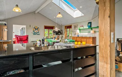 a kitchen with a large counter with a sink at Cozy Home In Spøttrup With Wifi in Lihme