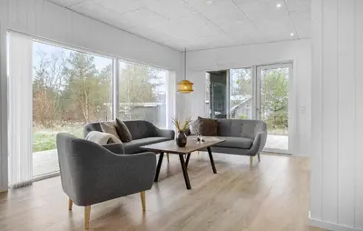 a living room with two chairs and a coffee table at 3 Bedroom Awesome Home In Fjerritslev in Fjerritslev