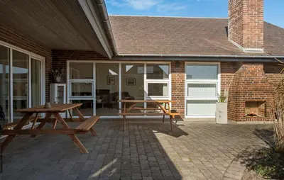 a patio with a picnic table on a brick house at Amazing Home In Thyborøn With Sauna in Thyborøn