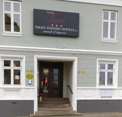 a small danish house with a sign above the door at Hotel Thisted in Thisted