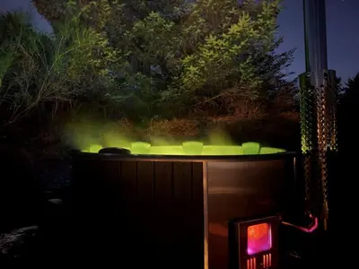 a hot tub with green lights in the dark at Holiday Home Annemone - 900m from the sea by Interhome in Blokhus