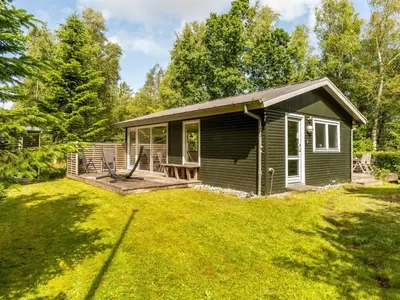 a small green house with a large yard at Holiday Home Elisabete - 200m to the fjord by Interhome in Fur