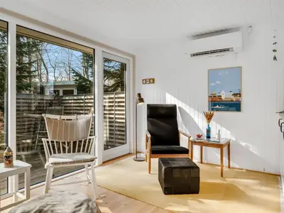 a living room with a chair and a table at Holiday Home Elisabete - 200m to the fjord by Interhome in Fur