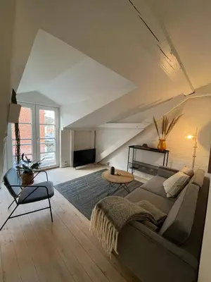 a living room with a couch and a table at Cozy Scandinavian Apartment in the Heart of Viborg in Viborg