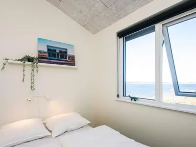 a bedroom with a bed and a window at 5 star holiday home in Løgstrup in Løgstrup