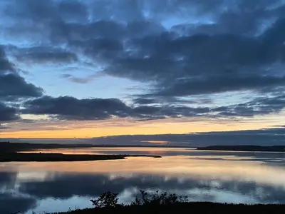 a view of a large body of water at sunset at 5 star holiday home in Løgstrup in Løgstrup