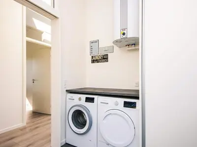 a white laundry room with a washer and dryer at 5 star holiday home in Løgstrup in Løgstrup