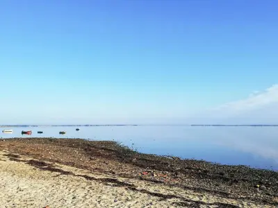 a beach with some boats in the water at 6 person holiday home in Spøttrup in Spottrup