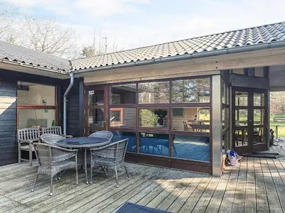 a patio with a table and chairs on a deck at 6 person holiday home in Spøttrup in Spottrup