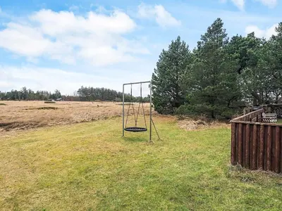 a swing set in the middle of a field at 6 person holiday home in Pandrup in Pandrup