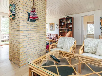 a living room with a brick wall at 6 person holiday home in Pandrup in Pandrup