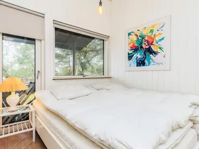 a bedroom with a bed and a window at 6 person holiday home in Pandrup in Pandrup