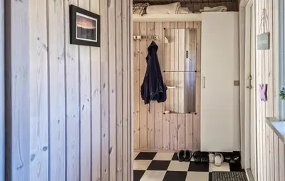 a hallway with wooden walls and a checkerboard floor at 3 Bedroom Cozy Home In Løkken in Løkken