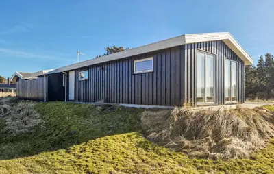 a house with a black siding at 3 Bedroom Cozy Home In Løkken in Løkken