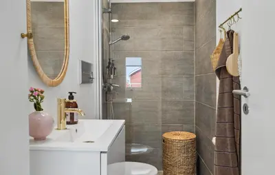 a bathroom with a sink and a shower at Cozy Apartment In Lemvig With Sauna in Lemvig