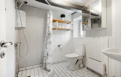 a white bathroom with a toilet and a sink at Nice Home In Farsø With Wifi in Farsø