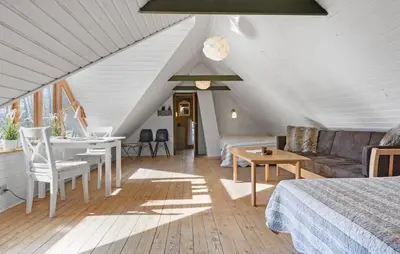 a room with a bed and a couch and a table at Nice Home In Farsø With Wifi in Farsø