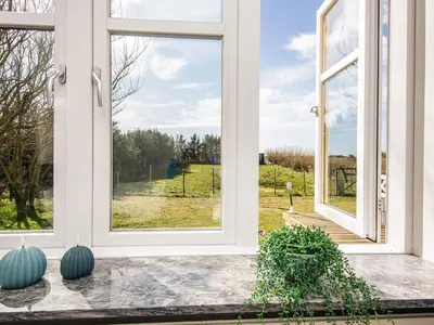 a room with a window with a view of a field at 4 star holiday home in Løkken in Løgsted