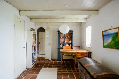 a dining room with a table and chairs in it at Cut Branches, Make Fire And Gaze At Treetops in Nykøbing Mors