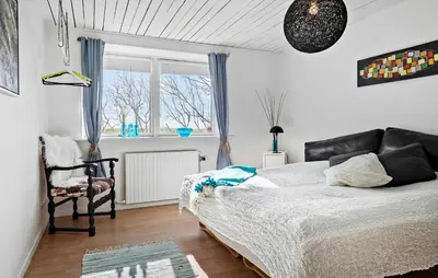 a bedroom with a bed and a chair and a window at Amazing Apartment In Thisted With Wifi in Thisted