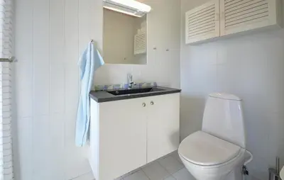 a white bathroom with a toilet and a sink at 2 Bedroom Nice Home In Roslev in Roslev