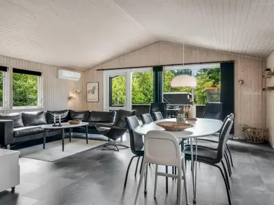 a living room with a table and chairs at Holiday Home Onni - 2-3km from the sea by Interhome in Saltum