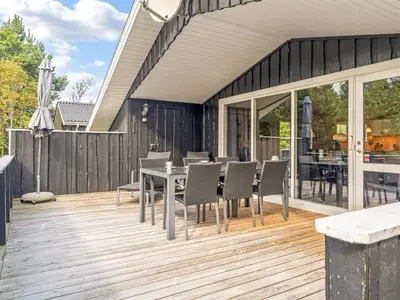 a patio with a table and chairs on a deck at Holiday Home Onni - 2-3km from the sea by Interhome in Saltum