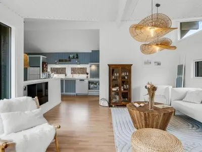a living room with a couch and a table at Holiday Home Gundborg - 200m from the sea by Interhome in Saltum