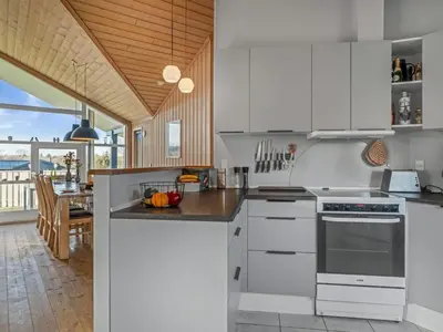 a kitchen with white appliances and a dining room at Holiday Home Anline - 600m to the fjord by Interhome in Farsø