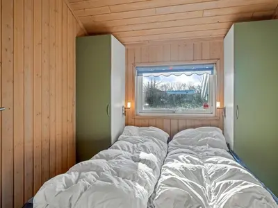a large bed in a room with a window at Holiday Home Anline - 600m to the fjord by Interhome in Farsø