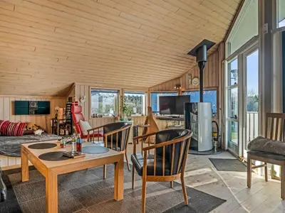 a living room with a table and chairs at Holiday Home Anline - 600m to the fjord by Interhome in Farsø