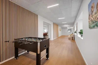 an office with a foosball table in the middle of a room at Exclusive Pool Houseconference Center With Gymnasium in Erslev