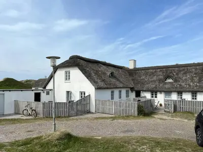a large white house with a thatched roof at North Sea Atmosphere On The Farm In Klitmøller in Torsted