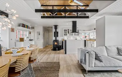 a living room and kitchen with a table and a couch at Nice Home In Blokhus With Wifi in Blokhus