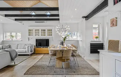 a kitchen and living room with a table and chairs at Nice Home In Blokhus With Wifi in Blokhus