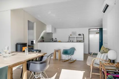 a kitchen and living room with a table and chairs at Lovely Holiday Home With Panoramic View Of The Fjord in Amtoft