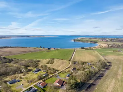 an aerial view of a farm and a lake at Holiday Home With Pool And Spa Close To The Limfjord in Roslev